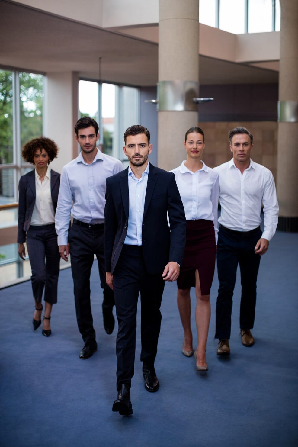 Business professionals walking together in a corporate office