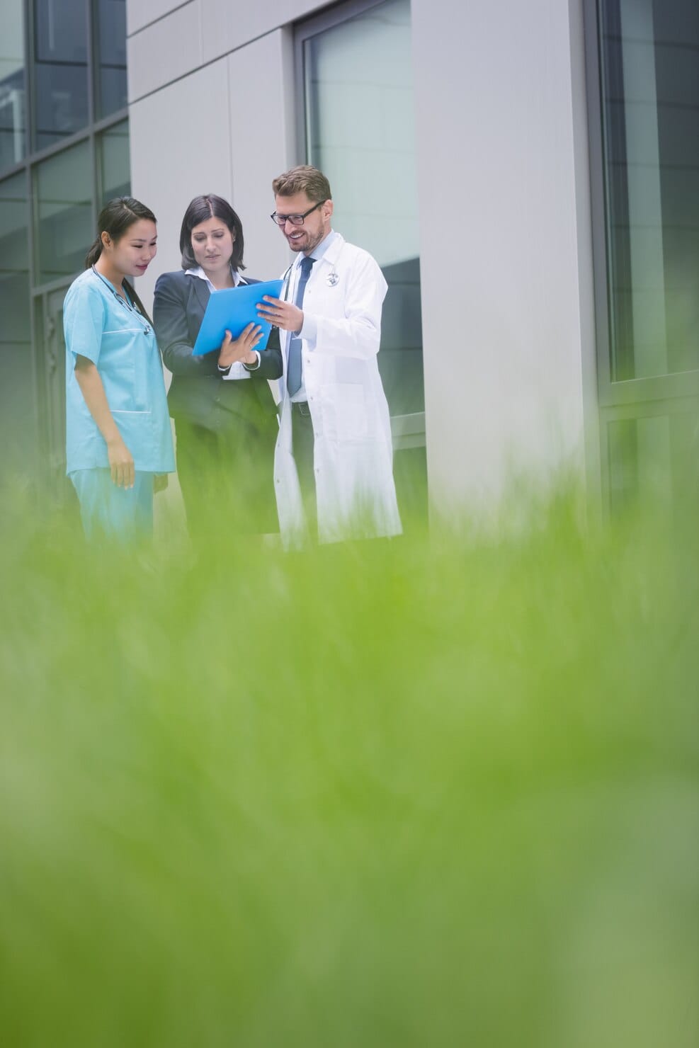 Doctors and nurse discussing a medical report in a healthcare facility